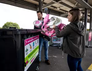 two people recycling electrical items and toys at the recycling centre in Merseyside